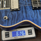 Blue electric guitar on a digital scale displaying weight
