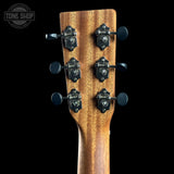 Close-up of a guitar headstock with tuning pegs on a black background, featuring the Tone Shop logo.