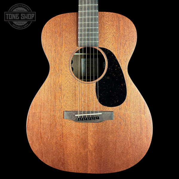Acoustic guitar with a visible brand logo on a black background