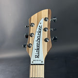 Guitar headstock with 'Rickenbacker' branding on a dark background