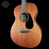 Acoustic guitar with a visible brand logo on a black background