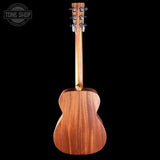 Wooden acoustic guitar on a black background with 'Tone Shop' logo.