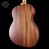 Wooden guitar back with 'Tone Shop' logo in the corner