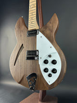 Wooden electric guitar with a focus on the body and control knobs against a dark background