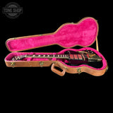 Guitar in a pink-lined case with 'Tone Shop' logo in the corner.