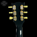 Guitar headstock with tuning pegs on a black background, featuring the Tone Shop logo.