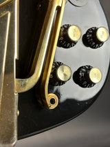 Close-up of a vintage radio with control knobs on a black background