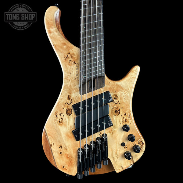 Wooden electric guitar with a black background, featuring the Tone Shop logo.