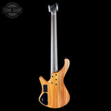 Electric bass guitar with a wooden body on a black background, featuring the Tone Shop logo.