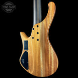 Wooden electric bass guitar on a black background with 'Tone Shop' logo.