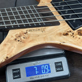 Guitar on a digital scale displaying weight