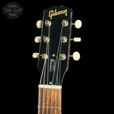 Gibson guitar headstock with brand logo on a black background