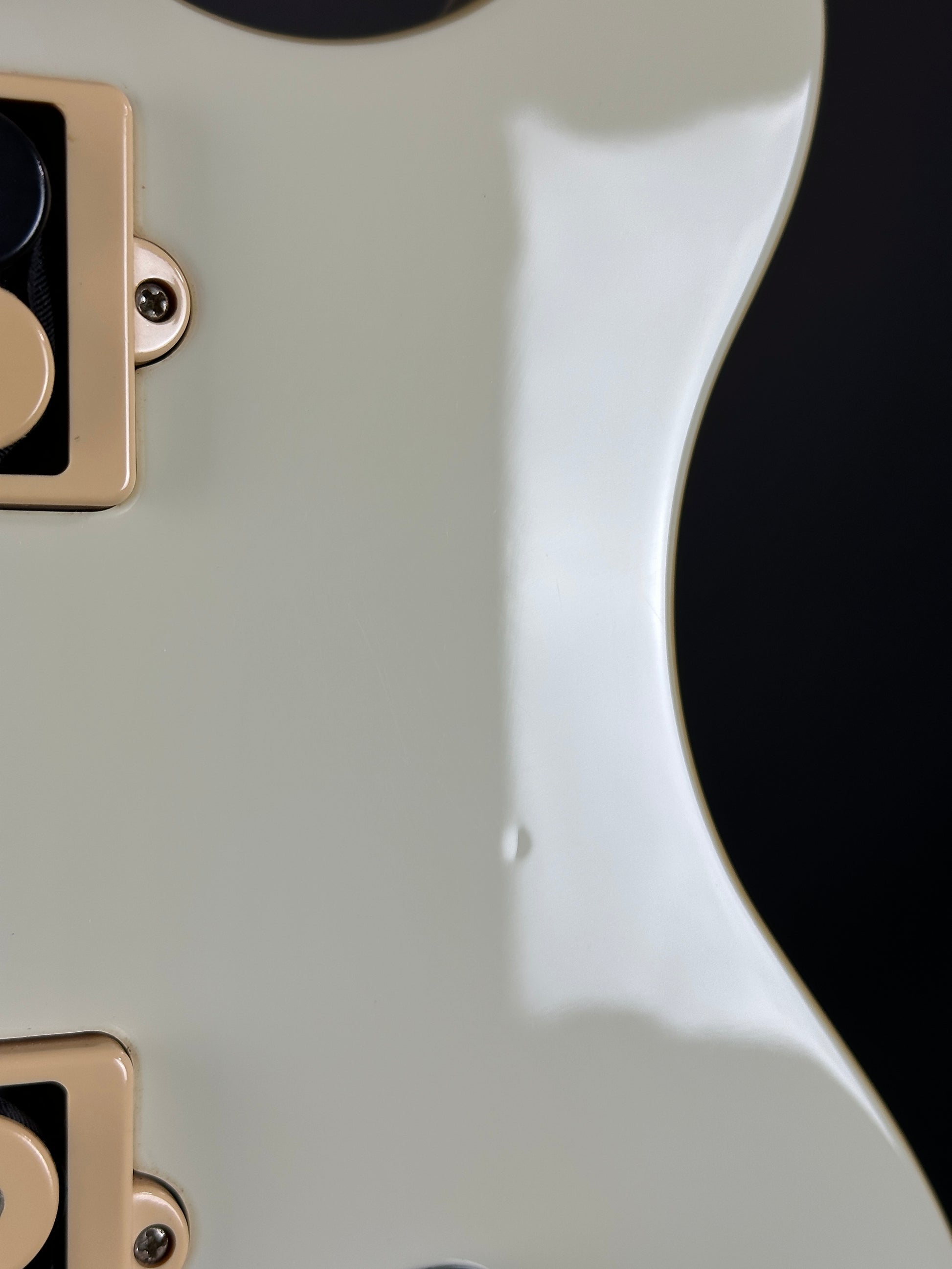 Ding on body of Used Ernie Ball Music Man Reflex White.