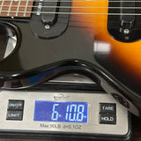 Electric guitar on a digital scale displaying weight