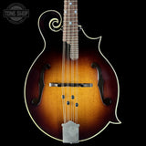 Mandolin with a dark brown finish on a black background, featuring the Tone Shop logo.