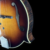 Close-up of a mandolin with a Gibson logo on a black background