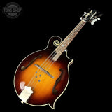 Fretted mandolin with a dark brown finish on a black background, featuring the Tone Shop logo.