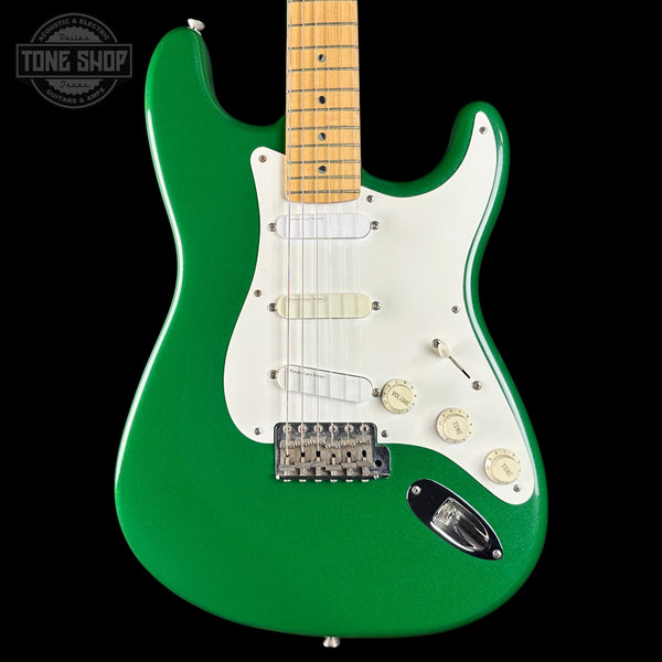 Green electric guitar with a white pickguard on a black background, featuring the Tone Shop logo.