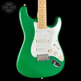 Green electric guitar with a white pickguard on a black background, featuring the Tone Shop logo.