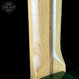 Close-up of a guitar neck with a clear finish, branded 'Tone Shop'.