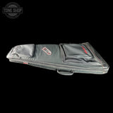 Black guitar case with a visible brand logo on a black background