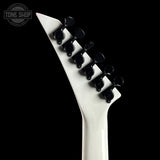 Close-up of a white electric guitar neck with black tuning pegs on a black background, featuring 'Tone Shop' logo.
