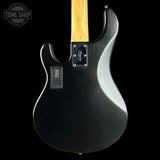 Black electric guitar with a visible brand logo on a black background