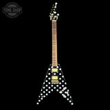 Electric guitar with a black and white polka dot design on a black background, featuring the Tone Shop logo.