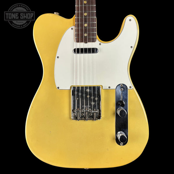 Yellow electric guitar with a white pickguard on a black background, featuring 'Tone Shop' branding.