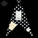 Black guitar pickguard with white polka dots on a black background, featuring the Tone Shop logo.