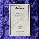 Jackson guitar certificate on a textured purple surface