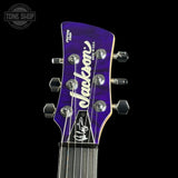 Jackson guitar headstock with logo on a black background