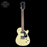 White electric guitar on a black background with 'Tone Shop' logo.