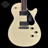 White electric guitar with a black pickguard on a white background