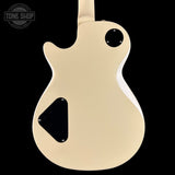 Beige electric guitar body with black pickguard on a black background, featuring 'Tone Shop' logo.