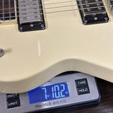 Guitar on a digital scale displaying weight