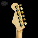 Guitar headstock with tuning pegs on a black background, featuring the Tone Shop logo.