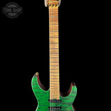 Green electric guitar with a black background