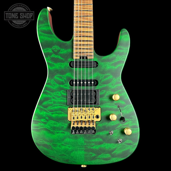 Green electric guitar with a black pickguard on a black background, featuring 'Tone Shop' branding.