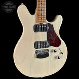 Electric guitar with a white body and red pickguard on a black background, featuring the Tone Shop logo.