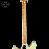 Close-up of a guitar neck with a black background