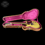 Guitar in a pink-lined case with 'Tone Shop' logo in the corner.