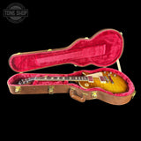 Gibson Les Paul guitar in a red-lined case with 'Tone Shop' logo.