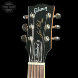 Gibson Les Paul guitar headstock with brand name on a black background