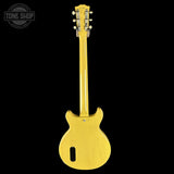 Yellow electric guitar with a 'Tone Shop' logo in the corner