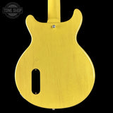 Yellow electric guitar body with 'Tone Shop' logo in the corner.