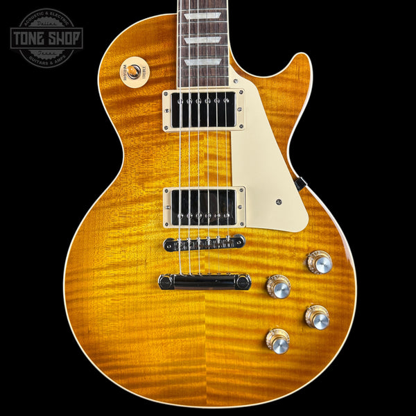 Electric guitar with a sunburst finish on a black background, featuring the Tone Shop logo.