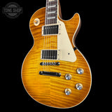 Electric guitar with a sunburst finish on a black background, featuring the Tone Shop logo.