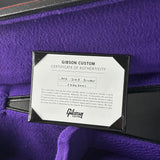 Gibson Custom Certificate of Authenticity on a purple surface