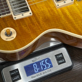Electric guitar on a digital scale displaying weight